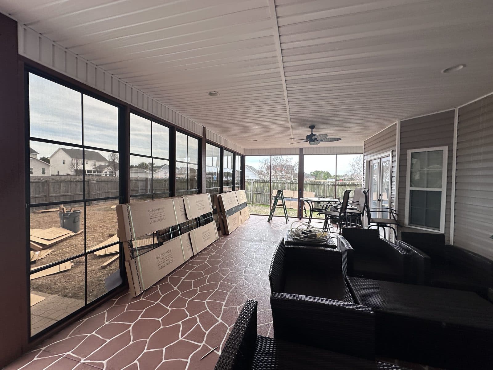 EZ Breeze panels being installed on a screen porch
