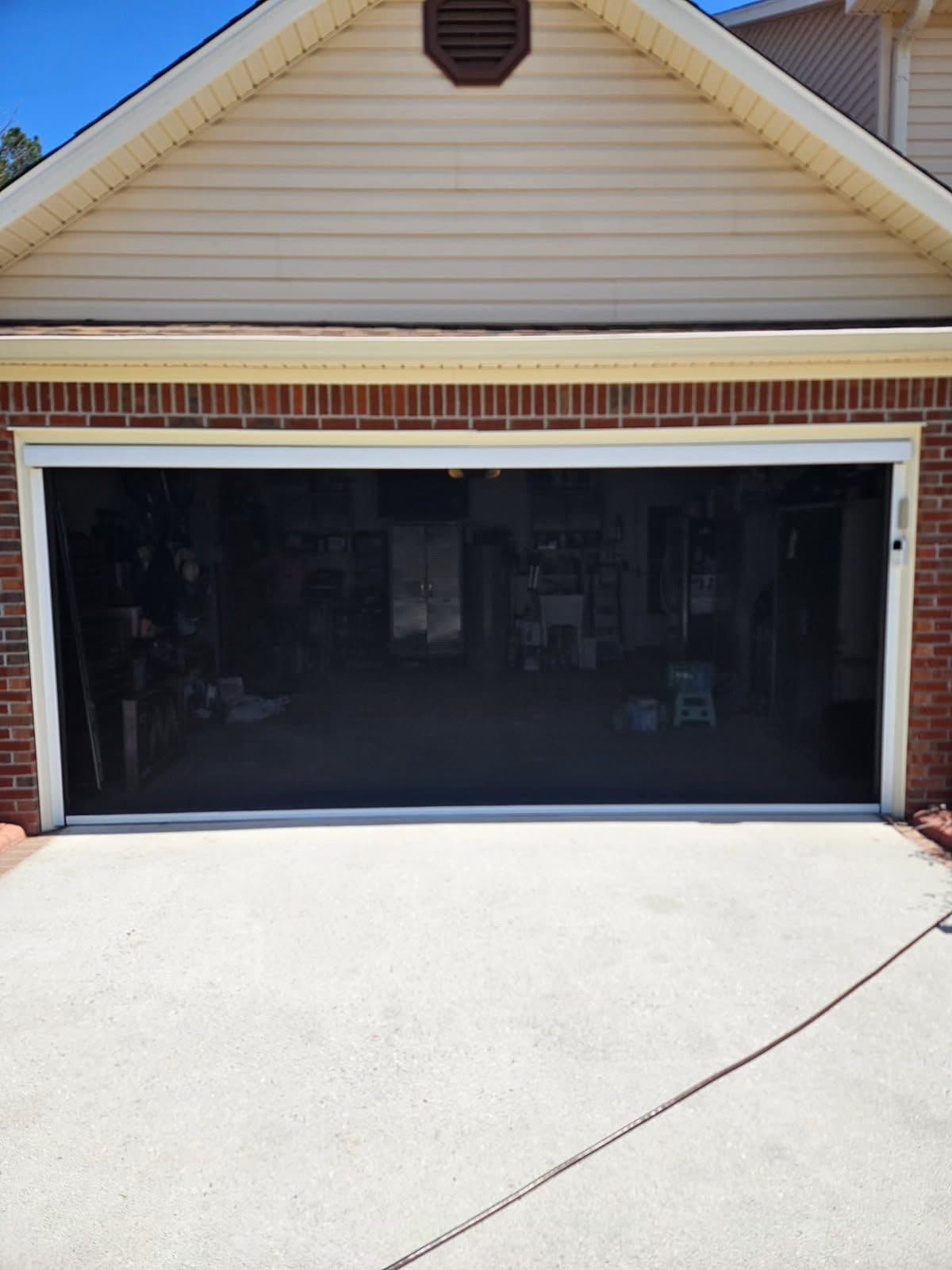 Motorized garage screen door installation