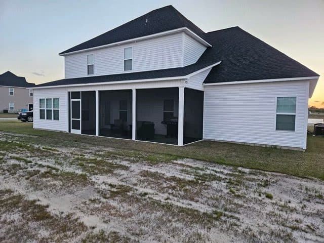 Screen room addition on a two-story home